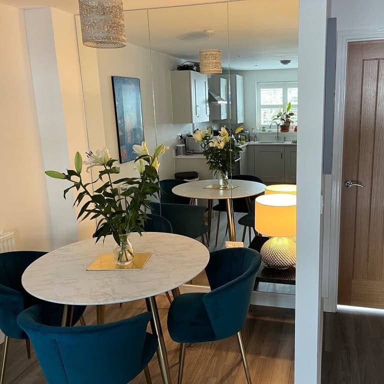 Full-height mirrored wall in an open-plan dining area